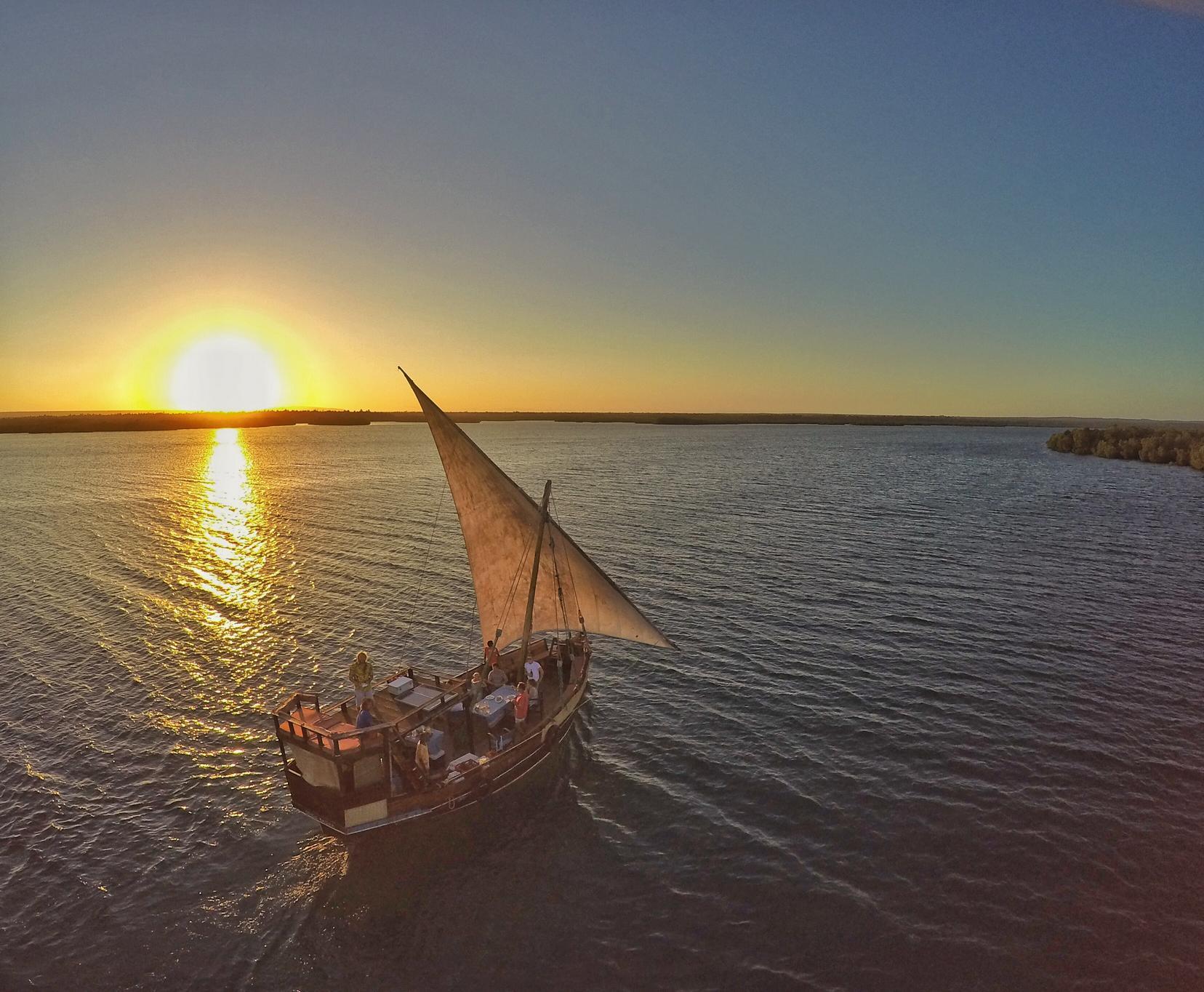 Traditional dhow sailing through Mida Creek at sunset in Watamu Kenya